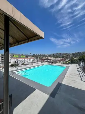 a large swimming pool with blue water in a building at Exceptional 2 BR in Heart of Hollywood 201 in Los Angeles