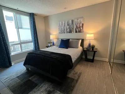 a bedroom with a bed and a large window at Exceptional 2 BR in Heart of Hollywood 201 in Los Angeles