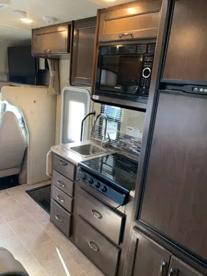 an rv kitchen with a sink and a microwave at AJ-XL RV Rental in Reseda