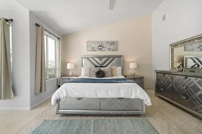 a bedroom with a large bed and a mirror at Japanese Garden Yorba Linda Hills Luxury Home in Yorba Linda