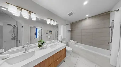a bathroom with two sinks and a tub and a toilet at 2 Bed 2 Bath Contemporary High Rise DTLA Living in Los Angeles