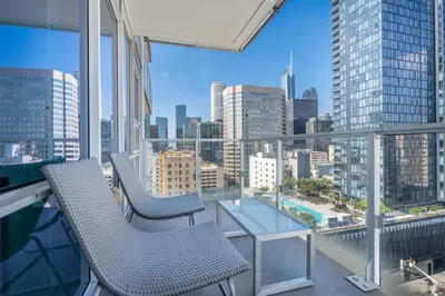 a balcony with two chairs and a view of the city at 2 Bed 2 Bath Contemporary High Rise DTLA Living in Los Angeles