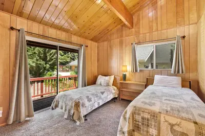 two beds in a room with a window at Inspiration point retreat #2470 in Big Bear Lake