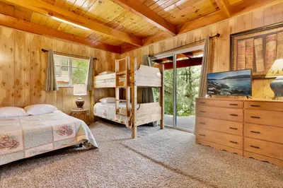 a bedroom with two bunk beds and a dresser at Inspiration point retreat #2470 in Big Bear Lake