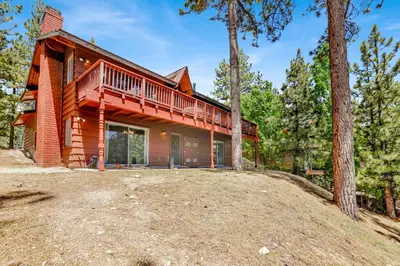 a log home with a deck in the woods at Inspiration point retreat #2470 in Big Bear Lake
