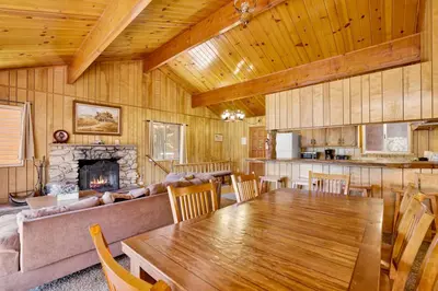 a living room with a table and a couch at Inspiration point retreat #2470 in Big Bear Lake