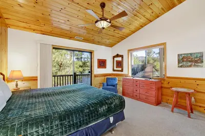a bedroom with a bed and a ceiling fan at Eagle point lake house #2471 in Big Bear Lake