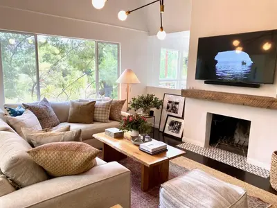 a living room with a couch and a fireplace at Zen Treehouse Retreat-Great Views & Peaceful Decks in Los Angeles
