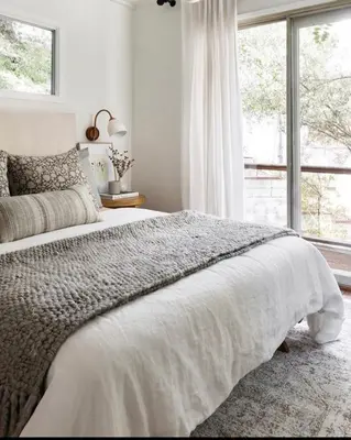 a white bedroom with a large bed and a window at Zen Treehouse Retreat-Great Views & Peaceful Decks in Los Angeles
