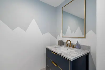 a bathroom with a sink and a mirror at Luxury Waterfront Home in the Heart of the Harbor in Huntington Beach