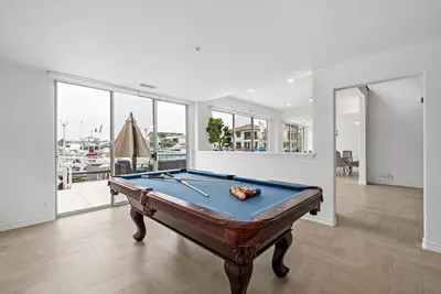 a billiard room with a pool table in a house at Luxury Waterfront Home in the Heart of the Harbor in Huntington Beach