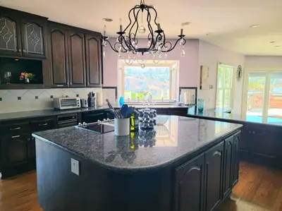 a kitchen with a large island in the middle at Luxury Hill Villa with Spectacular View in Anaheim
