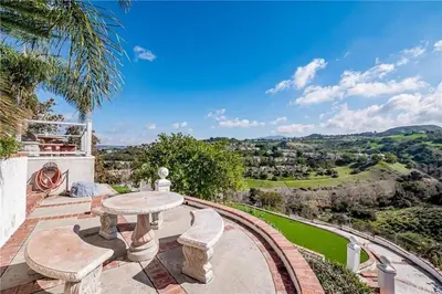 a patio with a table and chairs and a view at Luxury Hill Villa with Spectacular View in Anaheim
