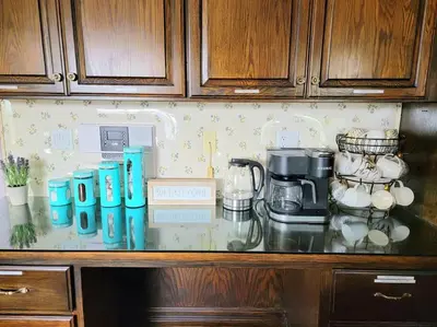 a counter top with a coffee maker and cups on it at Luxury Hill Villa with Spectacular View in Anaheim