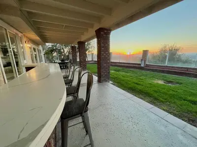 a porch with chairs and a table with a view at Top of the World Anaheim View Home in Anaheim