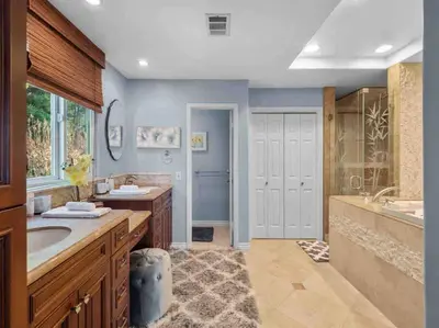 a bathroom with two sinks and a tub and a shower at Secluded Romantic Getaway Home in Anaheim