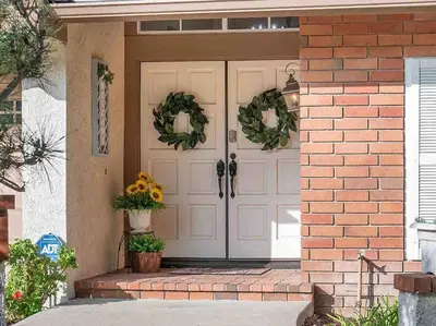 a front door of a house with wreaths on it at Secluded Romantic Getaway Home in Anaheim