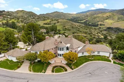 an aerial view of a house with mountains in the background at Luxury Oasis With Panoramic Views in Anaheim