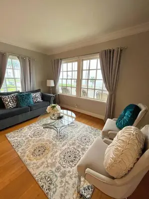 a living room with a couch and a table at Ocean Boulevard Beachfront Home in Long Beach