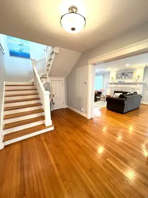 an empty living room with a staircase and a living room at Ocean Boulevard Beachfront Home in Long Beach