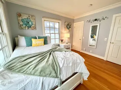 a bedroom with a large bed and a window at Ocean Boulevard Beachfront Home in Long Beach