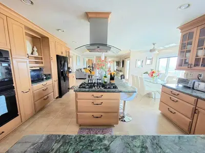 a large kitchen with a stove top oven in it at Majestic Anaheim Panorama Hill Home With Sunset in Anaheim