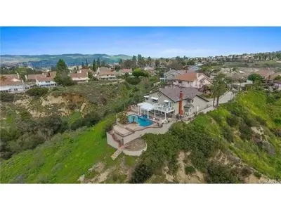 an aerial view of a house on a hill at Majestic Anaheim Panorama Hill Home With Sunset in Anaheim