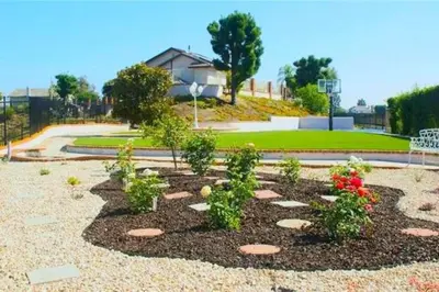 a garden with plants and flowers in a park at Stunning Panoramic Waterfront Pool Home Escape in Anaheim