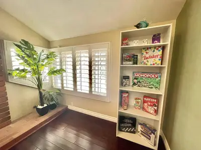 a room with a book shelf and a window at Stunning Panoramic Waterfront Pool Home Escape in Anaheim