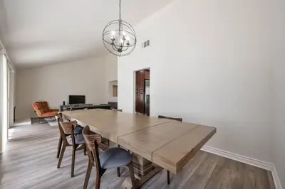 a dining room with a wooden table and chairs at Elm Mountain View Fire pit, quiet and more in Los Angeles