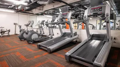 a gym with several treadmills and cardio machines at Holiday in LA - 1br with Free parking, Laundry, Pool in Los Angeles