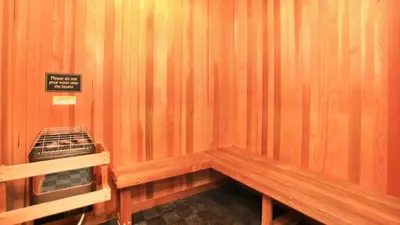 a wooden bench in a room with a sign on it at Holiday in LA - 1br with Free parking, Laundry, Pool in Los Angeles