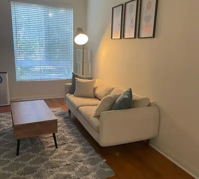 a living room with a couch and a table at Holiday in LA - 1br with Free parking, Laundry, Pool in Los Angeles