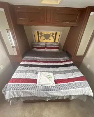 a large bed in a small room in a house at Rooms in Modern RV Trailer Home in Los Angeles
