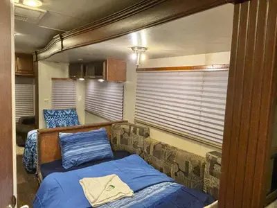 a small bedroom with a bed in a room at Rooms in Modern RV Trailer Home in Los Angeles