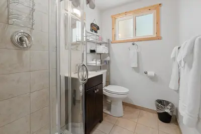 a bathroom with a shower and a toilet and a sink at Chateau Rouge - Walk to Lake & Village, AC, Pet Friendly! in Big Bear Lake