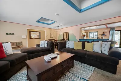 a living room with two couches and a coffee table at Wanderlust - Hot Tub, Foosball, Ping Pong, Walk to Lake & Village! in Big Bear Lake