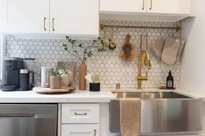 a kitchen with a stainless steel sink and white cabinets at Zen Birds Nest of Topanga Boho Chic with Epic Deck in Topanga
