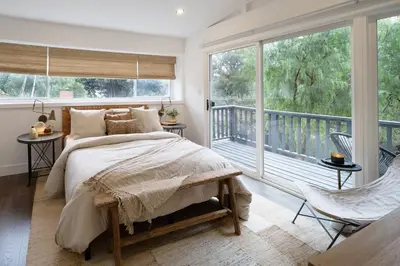 a bedroom with a bed and a large window at Zen Birds Nest of Topanga Boho Chic with Epic Deck in Topanga