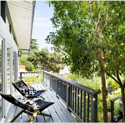 a porch with a bench and a chair on a deck at Zen Birds Nest of Topanga Boho Chic with Epic Deck in Topanga