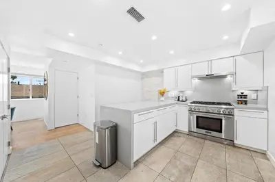 a kitchen with white cabinets and a stove top oven at The Diamond Dune - Upscale 3 Level 4BR Terrace Santa Monica in Los Angeles