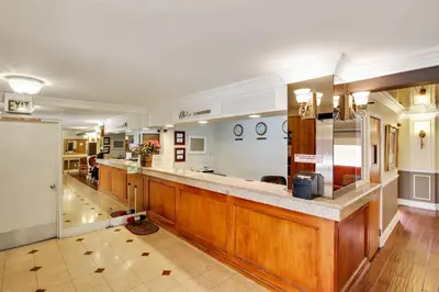 a large kitchen with wooden cabinets and a counter top at Rotex Western Inn in Los Angeles