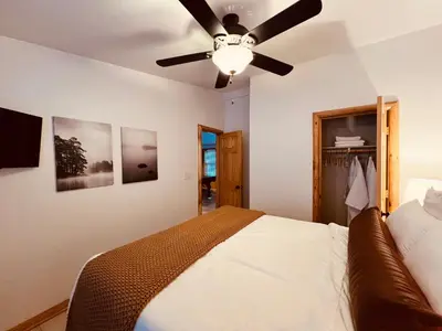 a bedroom with a bed and a ceiling fan at Château Bouli - 4 Season Escape and Games Room in Big Bear Lake