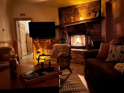 a living room with a couch and a fireplace at Château Bouli - 4 Season Escape and Games Room in Big Bear Lake