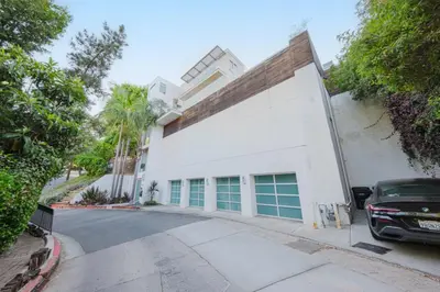 a white building with a car parked in front of it at Casa Azul in Los Angeles