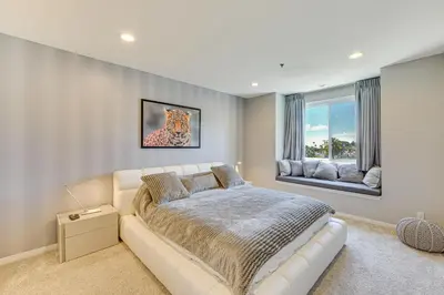 a bedroom with a white couch and a window at 2 Mi to Hollywood Condo with Pool and Hot Tub Access in Los Angeles