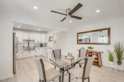 a kitchen and dining room with a glass table and chairs at 2 Mi to Citadel Outlets! East LA Retreat Near I-5 in Los Angeles