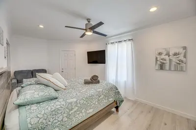 a bedroom with a bed and a ceiling fan at 2 Mi to Citadel Outlets! East LA Retreat Near I-5 in Los Angeles