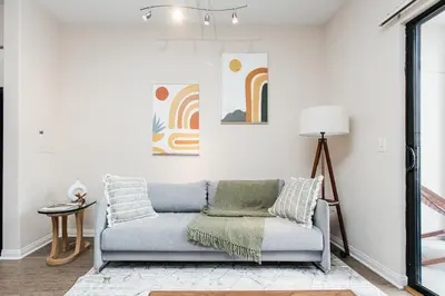 a living room with a couch and a lamp at Gorgeous studio steps from The Groove in Los Angeles