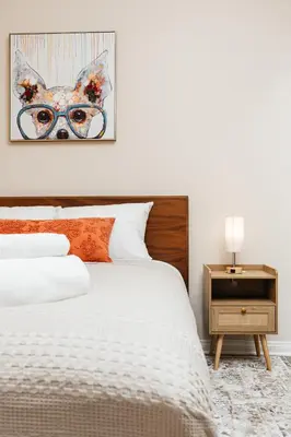 a bedroom with a bed and a picture of a dog at Gorgeous studio steps from The Groove in Los Angeles